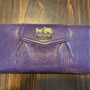 Beautiful deep purple Coach wallet. Good shape. Just a few scuffs from use.